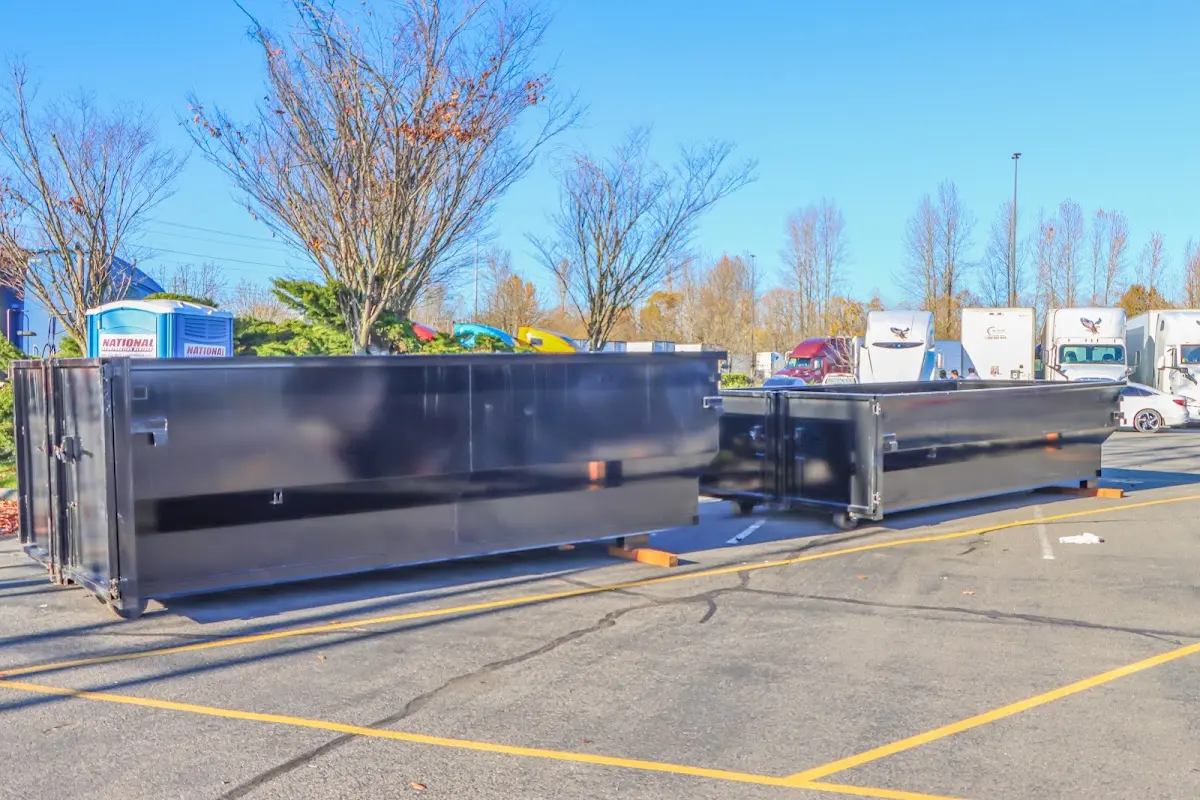 Professional dumpster rental service with roll-off container on residential driveway in Lake Mathews